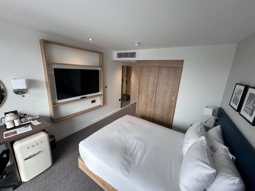 Hilton Garden Inn, Old Trafford - Photograph of the room showing the bed, tv, wardrobe and desk