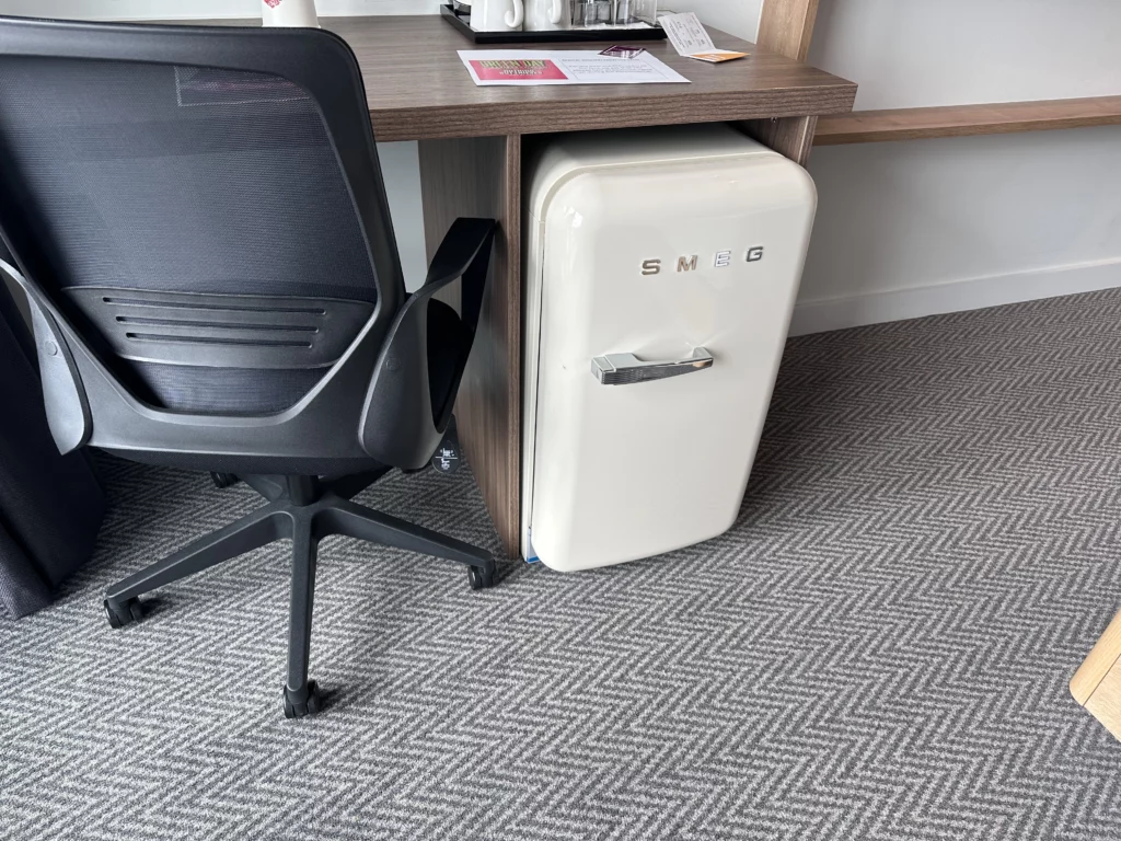 Hilton Garden Inn, Old Trafford - Photograph of the desk and Smeg fridge