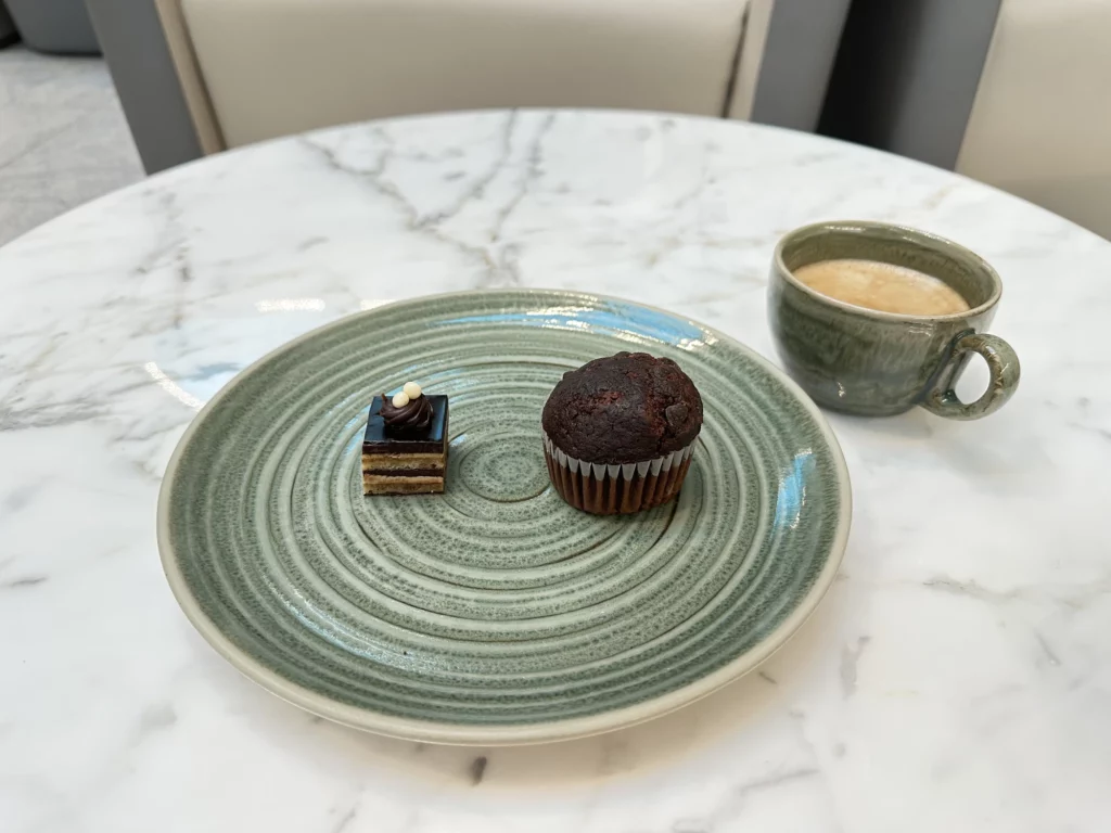 Photograph of a cake, muffin and coffee at the Pearl lounge