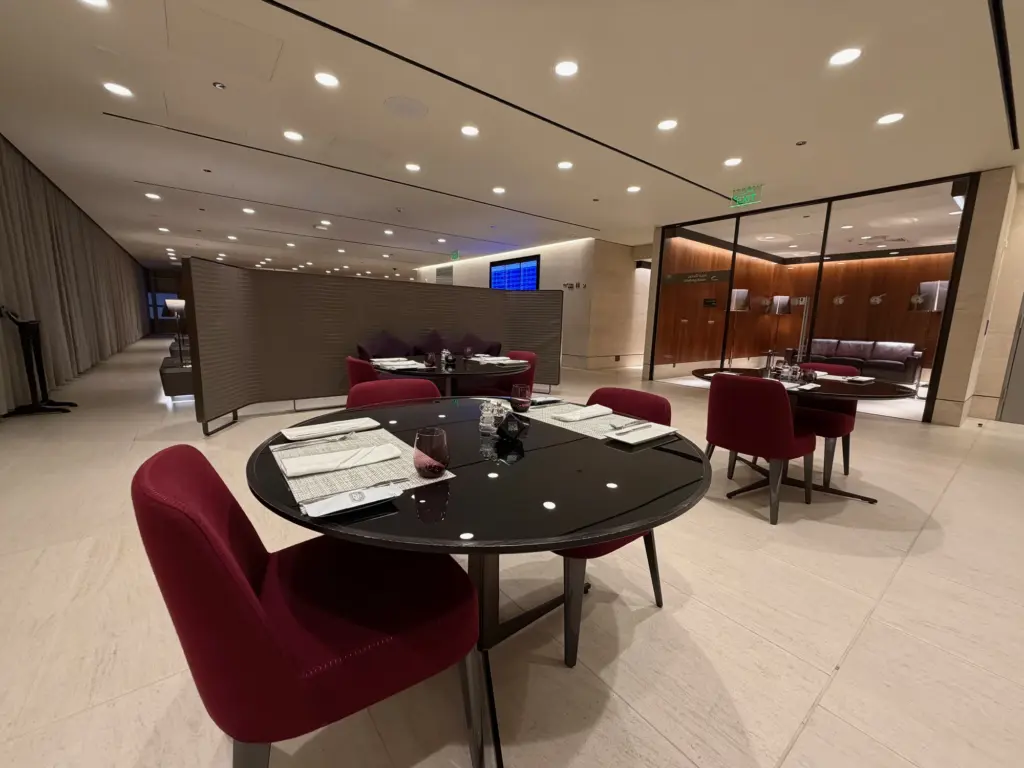 Dining seating at the far end of the lounge next to the self service food and drink counter