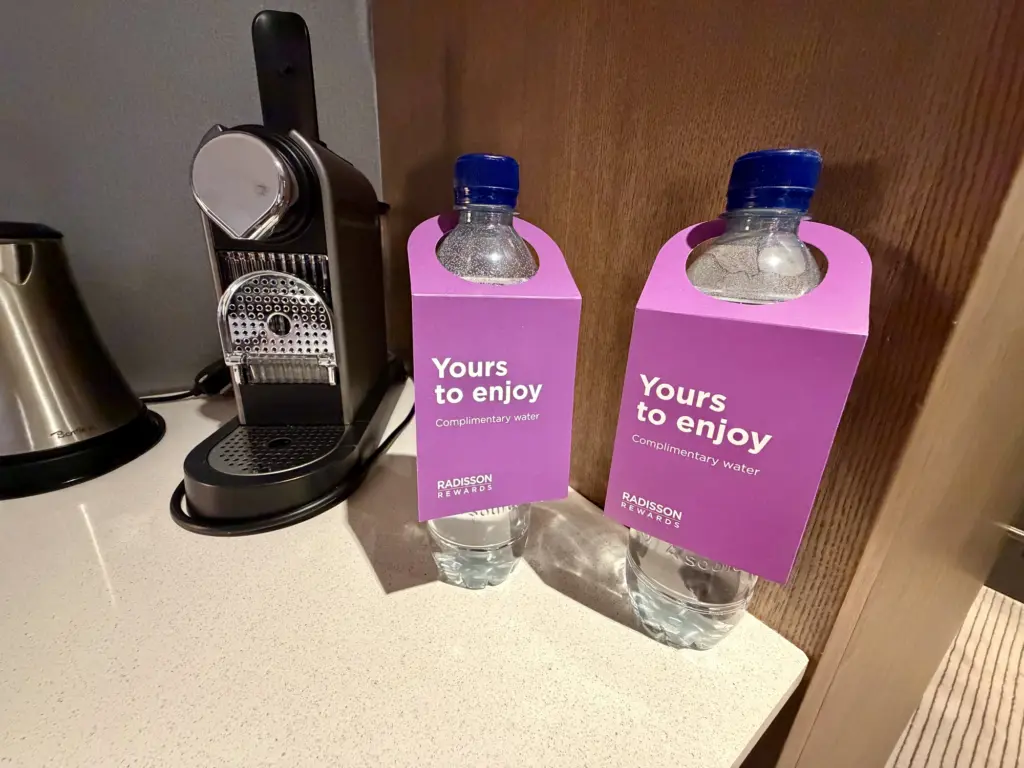 A Nespresso machine kettle and some complimentary water A Nespresso machine kettle and some complimentary water