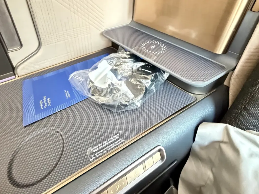 A useful surface with the seat controls just beneath it and the wireless shelf at the back A useful surface with the seat controls just beneath it and the wireless shelf at the back