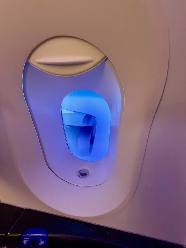 A toilet with a view thats one of the two 787 9 engines visible A toilet with a view thats one of the two 787 9 engines visible