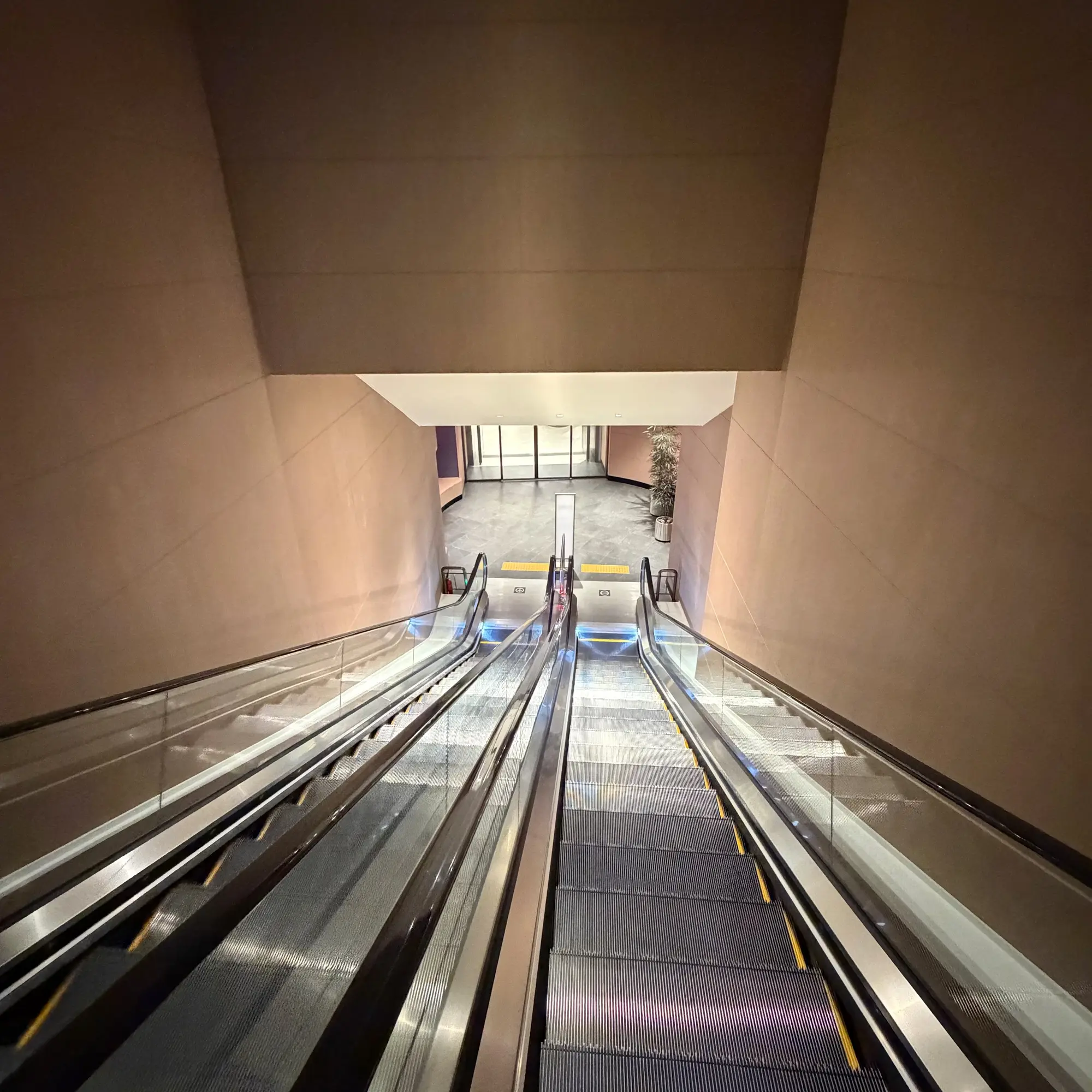 The escalators down to the basement shopping centre The escalators down to the basement shopping centre