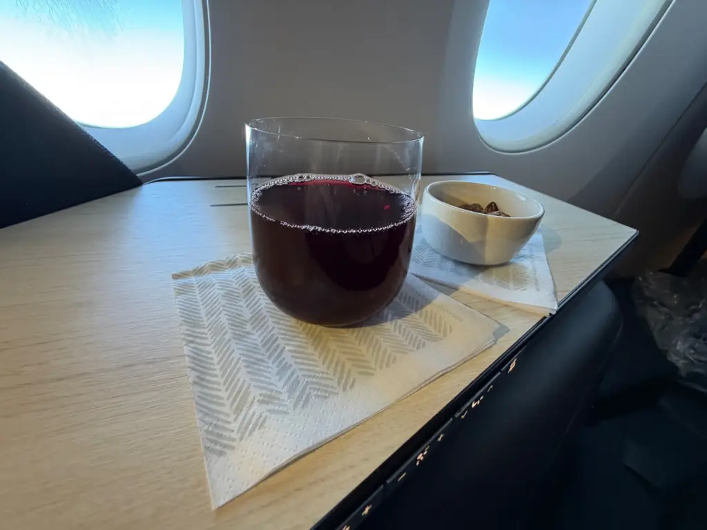 A blueberry welcome drink and some nuts A blueberry welcome drink and some nuts