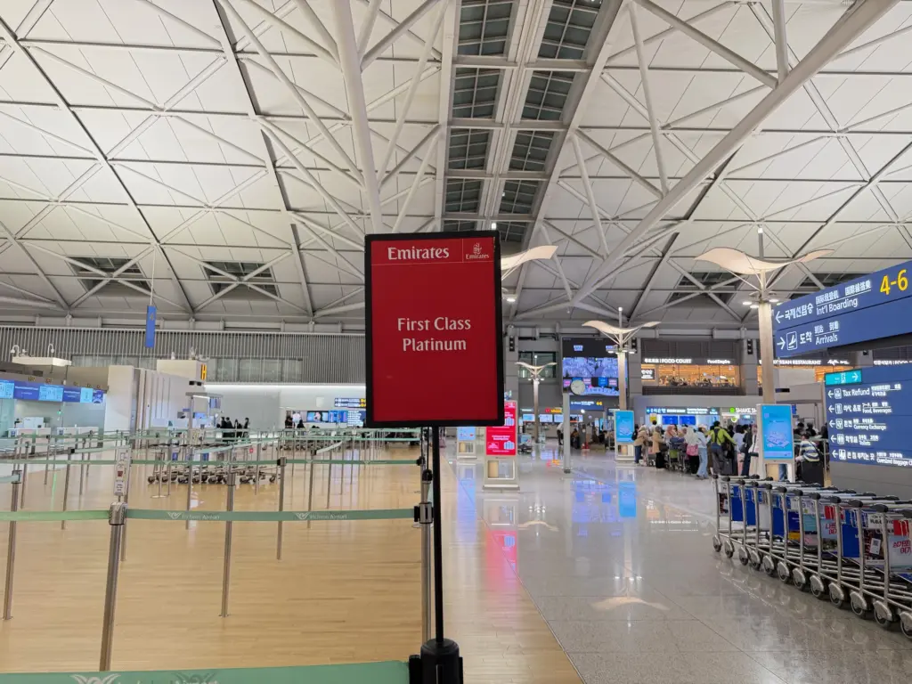 The Emirates First check in line Photograph of a sign showing the Emirates First check-in line