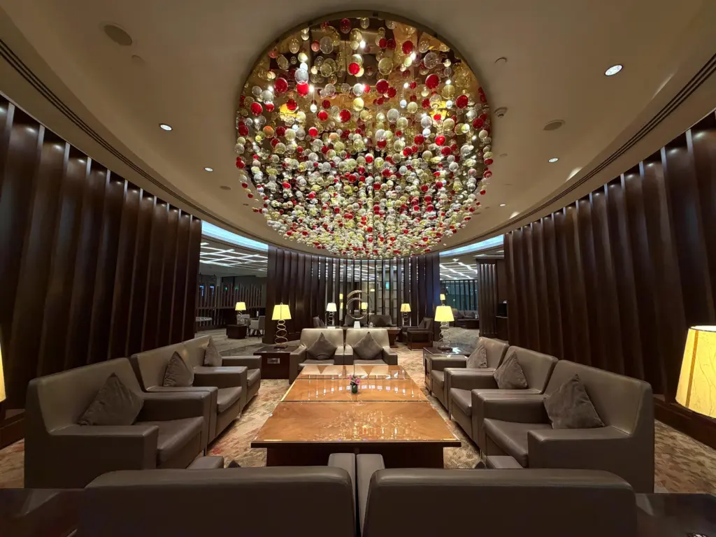 A stunning chandelier and seating inside the lounge A photograph of seating and a light installation in the Emirates First lounge