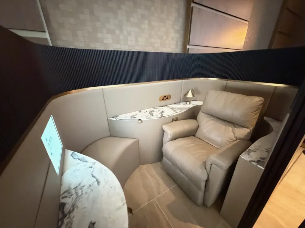 The private seating pods hidden away near our gate A photograph of a private seating pod inside the Emirate First lounge, near a gate