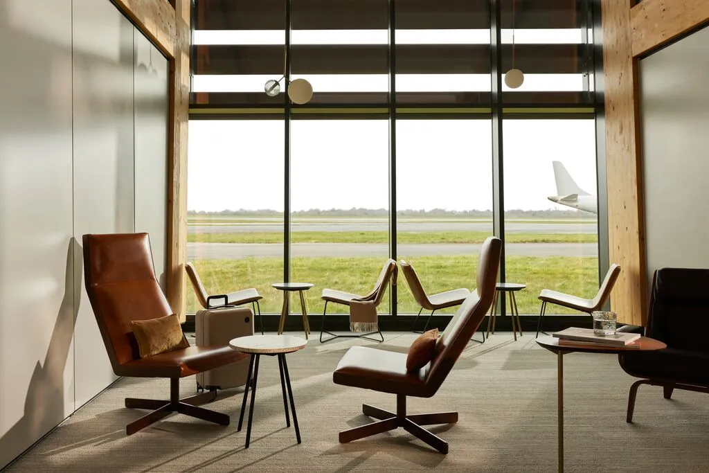 A photograph of the Aether private suite showing the views across the airport