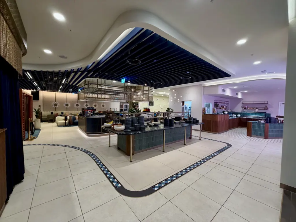 The Barista bar and coffee station in the background with healthy salad bar options in front of that