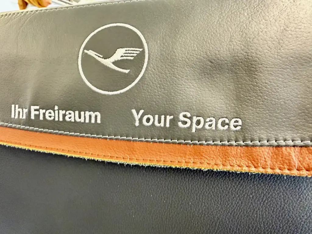 The headrest clearly marking that this isnt a seat to sit in A photograph of a headrest aboard a Lufthansa A320. The headrest reads "Your Space" and signifies at dividing seat in business class.