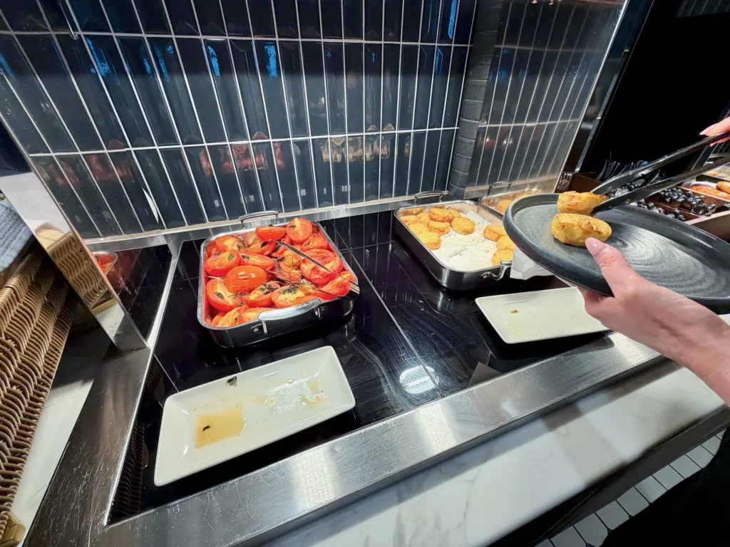 A photograph showing some hot food options within the lounge, including breakfast rosti