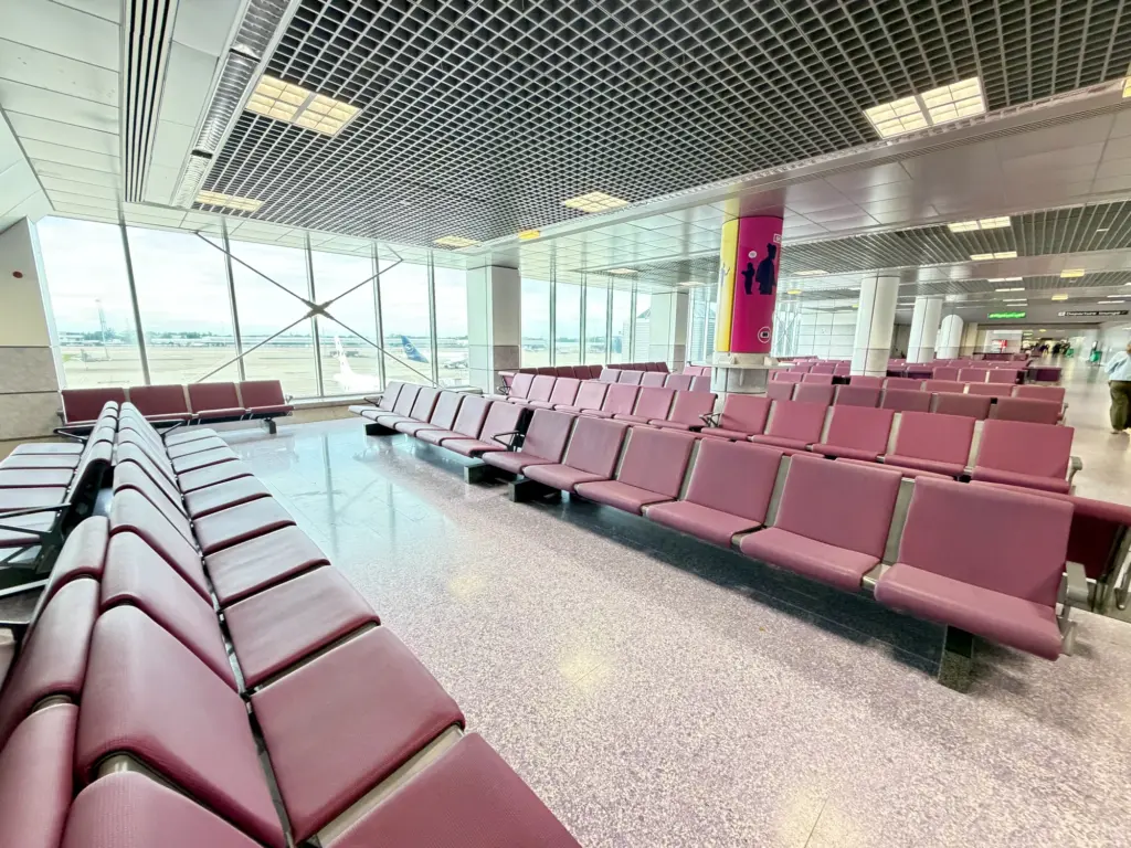 Our flight took off from the D gates which take you back in time A photograph of Manchester Airport Terminal 2, showing old seats dating back decades