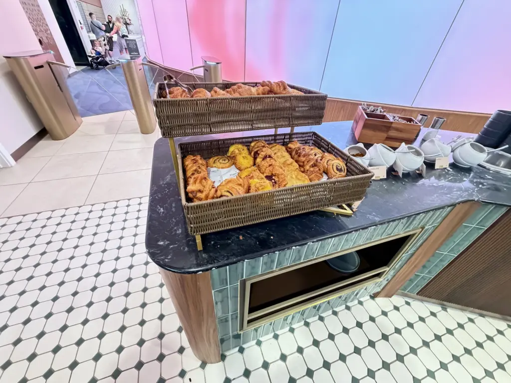 A photograph showing pastries within a basket inside an airport lounge