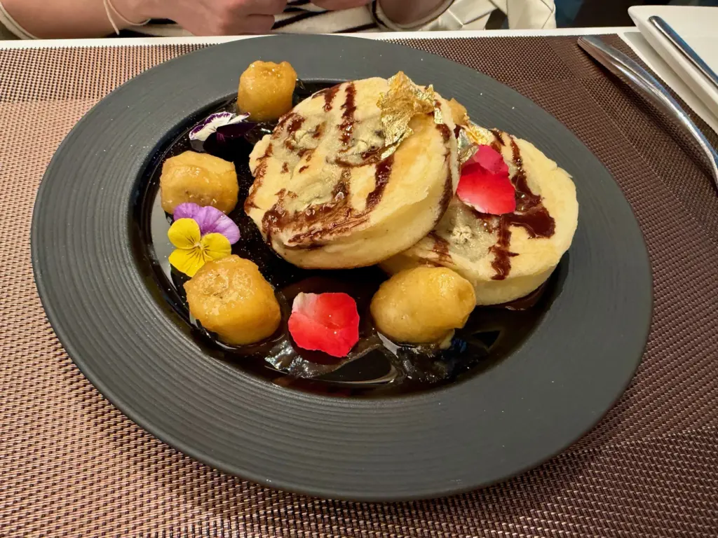 Banana and chocolate pancakes in the Qatar lounge A photograph of the banana and chocolate pancakes served in the Qatar lounge