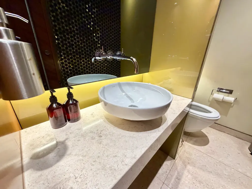 The no brand soaps in the bathroom A photograph of the sinks inside the Qatar lounge bathrooms