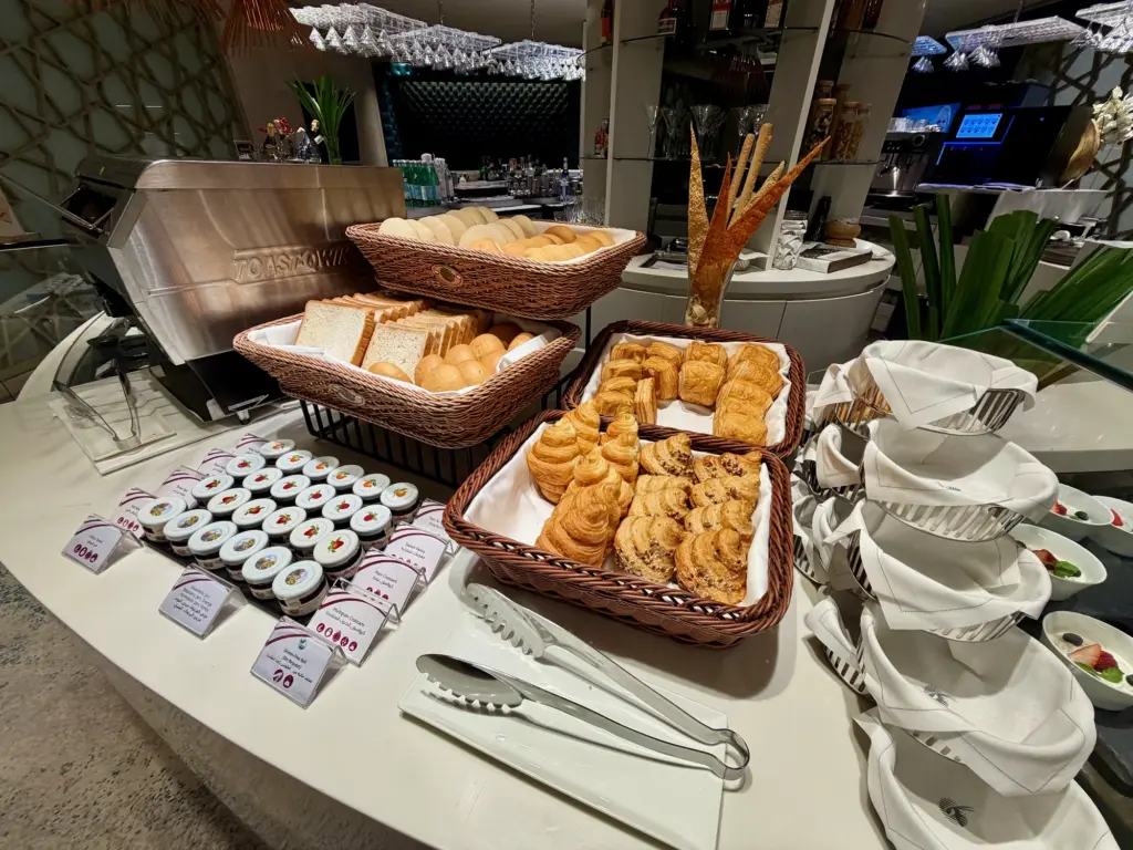Pastries bread and condiments in the buffet area A photograph showing the pastry and bread options inside the lounge