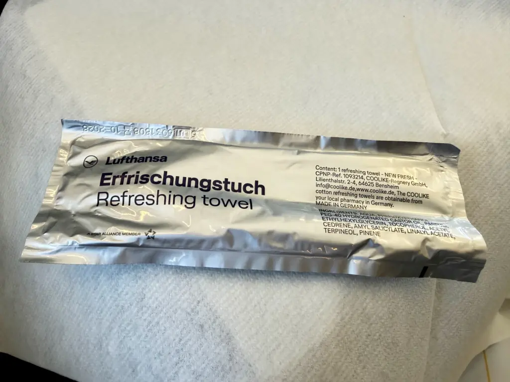 The refreshing towel A photograph of a refreshing towel inside a packet, handed out on a Lufthansa plane