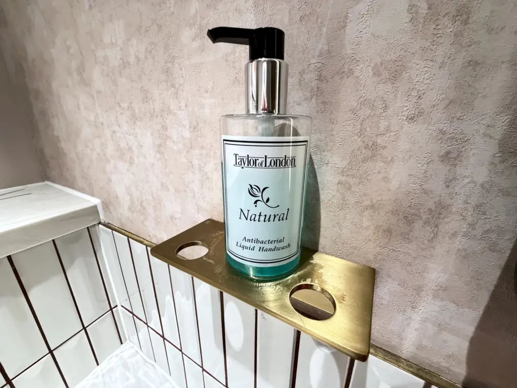 A photograph of a soap dispenser inside The Executive bathrooms